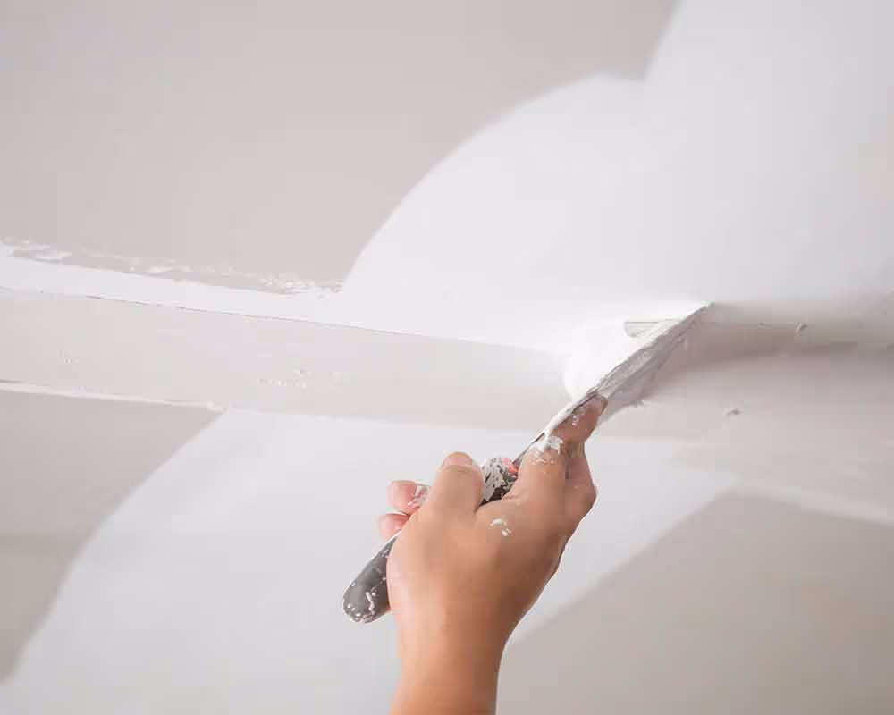 Professional drywall repair and texture matching on interior wall