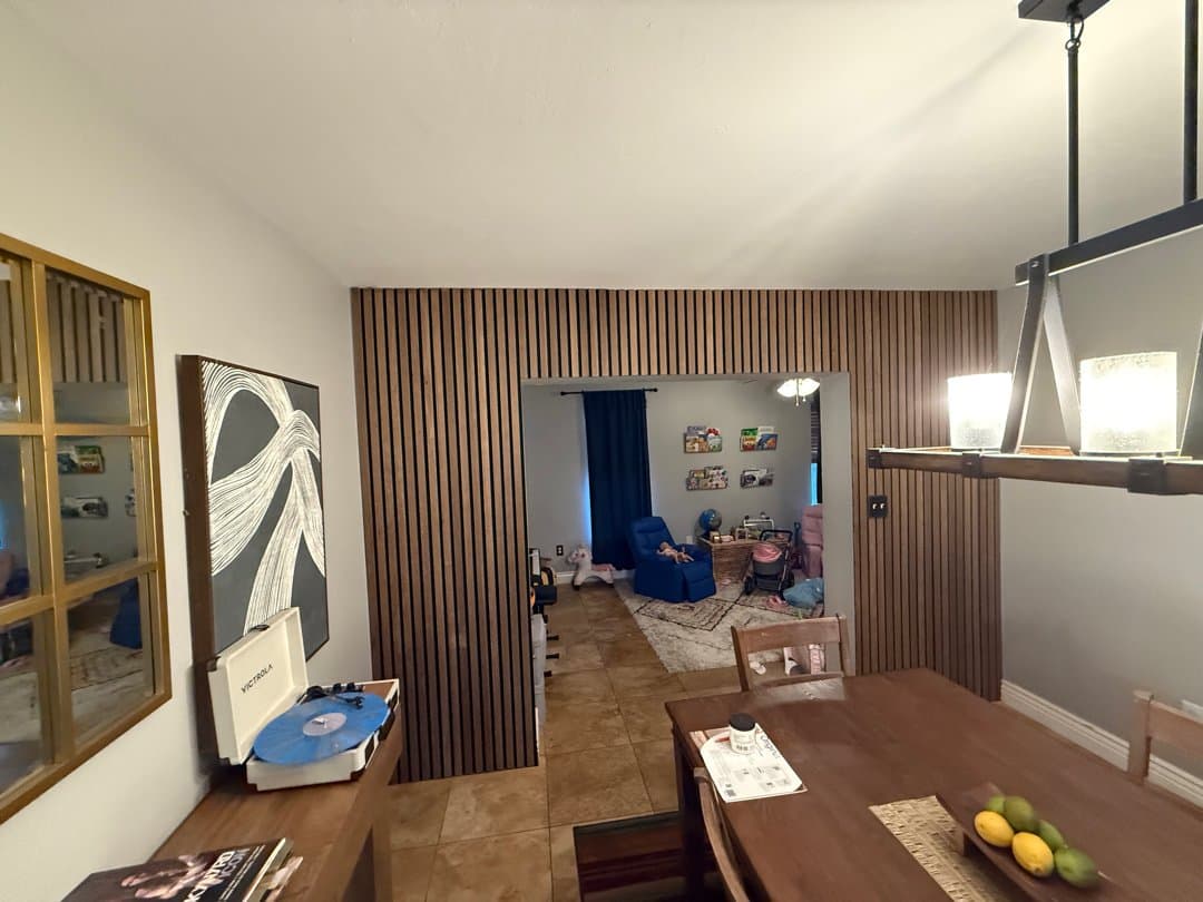 Modern wood slat accent wall installed in dining room with contemporary decor