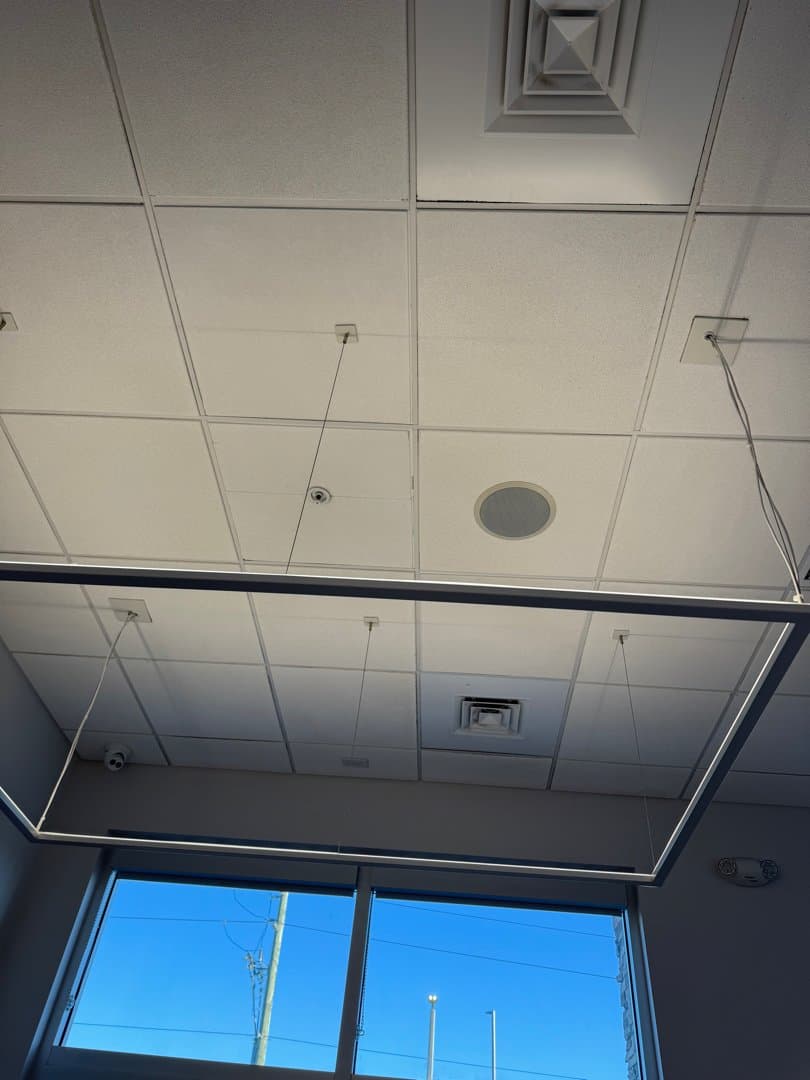 Repaired drop ceiling with new tiles and clean grid system