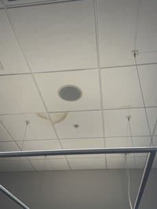 Damaged and sagging ceiling tiles with visible water staining