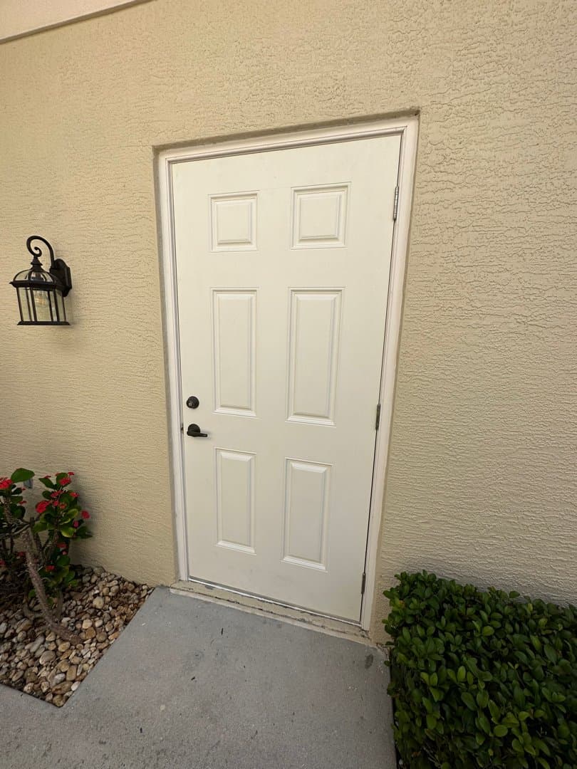 New white 6-panel exterior door with fresh trim and hardware