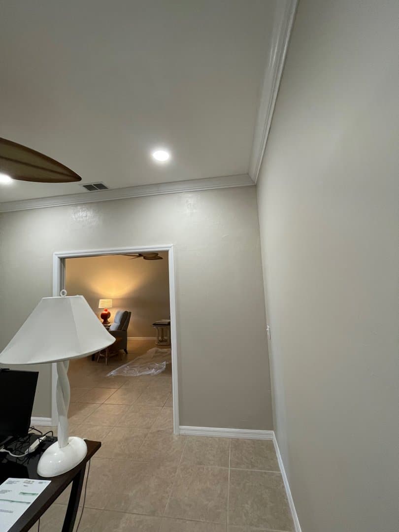 New wall built with doorway, crown molding, and baseboards to separate spaces