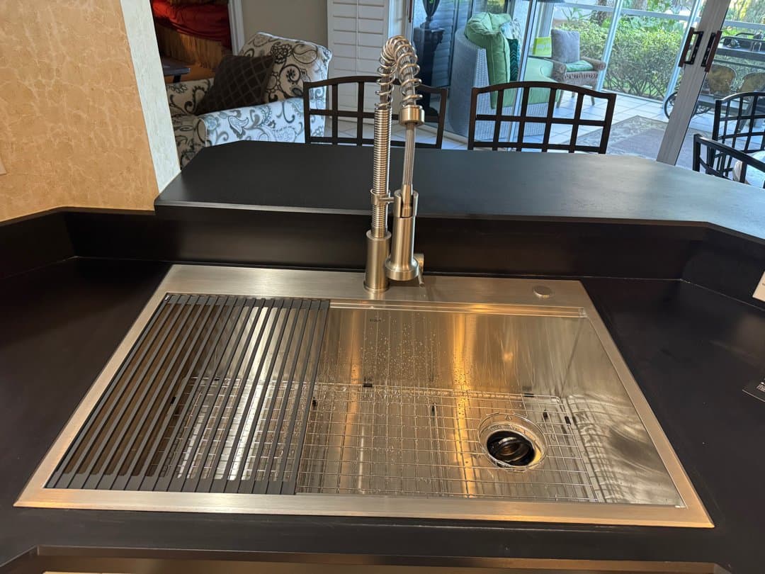 New stainless steel single-bowl workstation sink with pull-down faucet installed