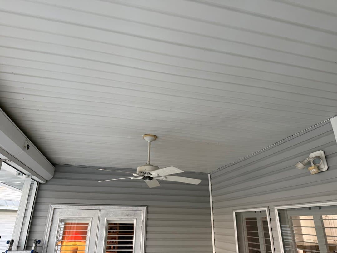 Restored lanai ceiling with new soffit panels and ceiling fan reinstalled